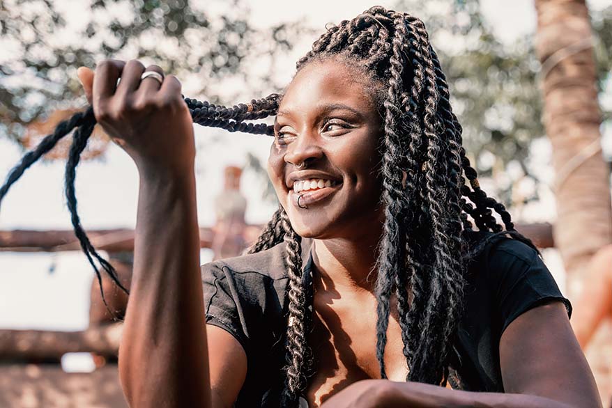 Charming beautiful young african american woman girl with black braided hair